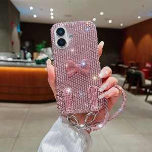 Detail of pink rhinestone phone case with bow and sparkling crossbody chain strap