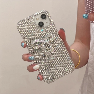 Close-up of luxury phone case with sparkling rhinestones and a large 3D crystal bow