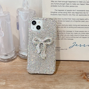 Detail showing high-end luxury full rhinestone bow design on iPhone protective case