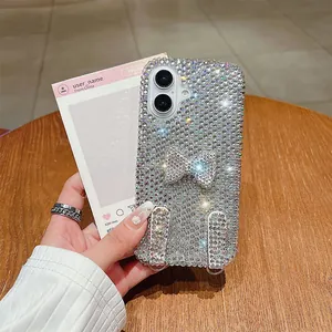 Detail of glittery bowknot rhinestones and metal lanyard loops on iPhone case