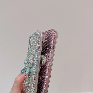 Detailed view of luxury full diamond bow phone cases for iPhone in silver and gradient purple