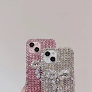 Detailed close-up of luxury rhinestones bow phone cases for iPhone in pink and silver
