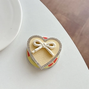 Detail of yellow heart phone grip with rhinestone border and polka dot bow decoration