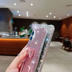 Detail of luxury rhinestone bow phone cases with sparkling full diamond texture for iPhone