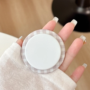 Close-up of magnetic phone grip with light purple plaid pattern on white background