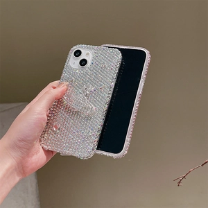 Detailed view of luxury iPhone case featuring sparkling rhinestones and a Saturn ring design