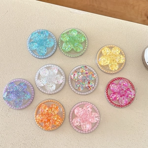 Set of nine colorful sequin flower magnetic phone grips with pearl bead edges on beige base