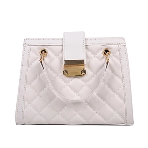 White quilted crossbody bag with golden chain strap and square metal lock on front