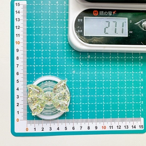 Macro shot of 3D green resin butterfly phone socket grip showing size on cutting mat