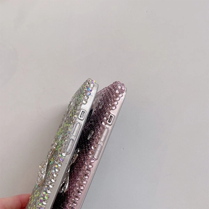 Close-up of luxury rhinestone phone case for iPhone with colorful crystals and character detail