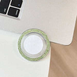 Detail of round phone socket with dual-row light green rhinestones on clear base
