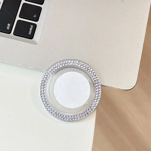 Detail shot of a round phone grip featuring double rows of purple rhinestones and white center