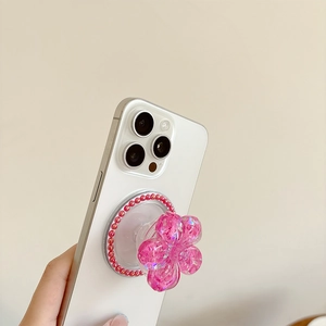 Macro view of 3D pink flower phone grip with glitter and pearl rim on white phone