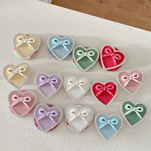 Sparkling rhinestone heart phone socket grip with bow and leather texture in multiple colors