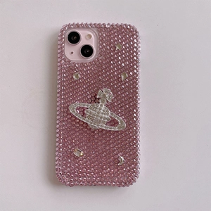 Macro shot of pink rhinestone phone case featuring a crystal Saturn planet ornament