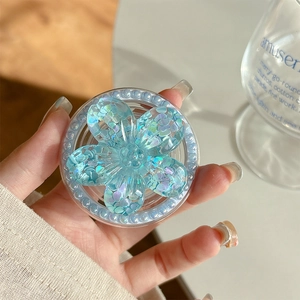 Close-up of blue glitter flower magnetic phone grip with pearly beads and sparkling sequins