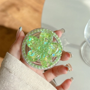 Detail of magnetic phone grip featuring a light green sequin flower and pearl edges