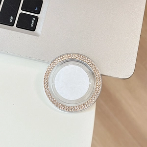 Close-up of a round mobile phone grip with double-row golden rhinestones and acrylic base