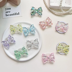 Glittery bow-shaped magnetic phone socket stand in various vibrant colors for smartphones
