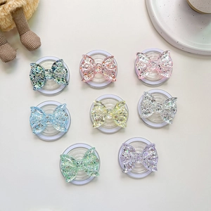Detail of glitter bow magnetic phone sockets in various colors with translucent finish