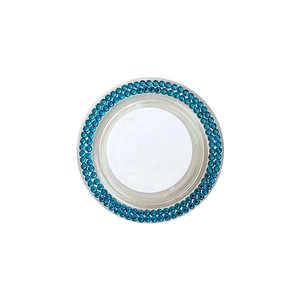 Sparkling dark blue rhinestone car engine start button decorative ring on white background