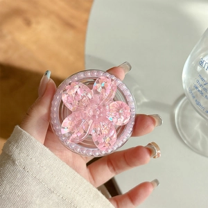 Close-up of pink flower phone grip with glitter sequins and elegant pearl border