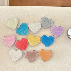 Glitter star heart phone socket grip set in eleven vibrant colors with shell texture
