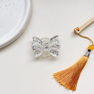 Macro shot of glittery butterfly phone grip with silver sequins and clear resin finish