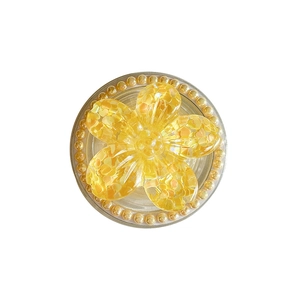 Floral magnetic phone socket with yellow heart sequins and pearl trim on white backdrop