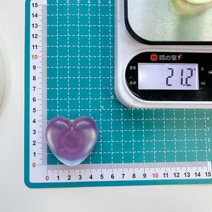 Macro detail of a 4.5cm purple heart resin phone grip on a measurement scale