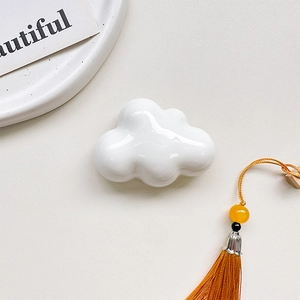 Detail shot of the glossy white cloud-shaped retractable magnetic phone grip stand