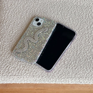 Macro shot of silver rhinestone snake phone case with sparkling diamond texture