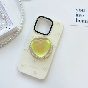 Chic cream phone case with iridescent heart grip, pearl trim and bow patterns