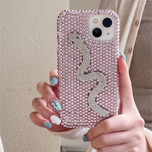 Macro shot of pink rhinestone phone case with silver sparkling snake for iPhone