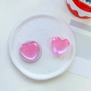 Detail view of pink pearlescent heart phone socket on creative ceramic plate decor