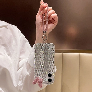 Close-up of luxury rhinestone iPhone case with pink crystal wrist strap and bow charm