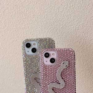 Detail of luxury rhinestone iPhone case with 3D snake accessory in pink and silver