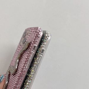 Macro view of crystal rhinestones and silver snake relief on iPhone protective case