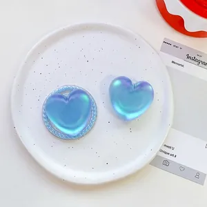 Detailed view of iridescent heart phone sockets with pearl finish on a white tray