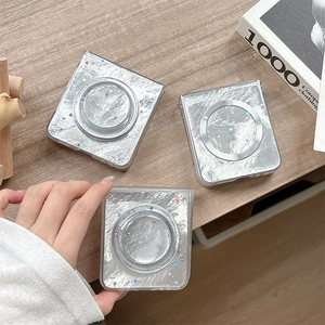 Detail of silver foil texture phone case for Samsung Z Flip with laser stars on wood table