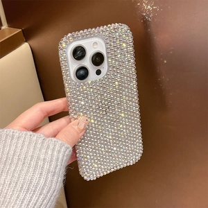 Close-up of sparkling full rhinestone iPhone case with silver metallic edges and hand strap