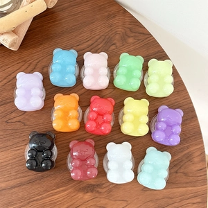 Candy-colored bear phone sockets in 13 vibrant glossy resin styles on wooden desk