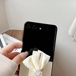 Close-up of leather phone case with camellia flower, pearl, and bow for Samsung Z Flip