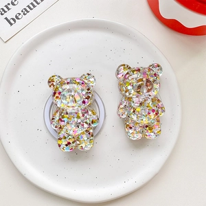 Detailed close-up of glitter-filled resin bear phone grips with sparkly sequins