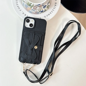 Detail of black litchi grain leather phone case with bow card holder and crossbody strap