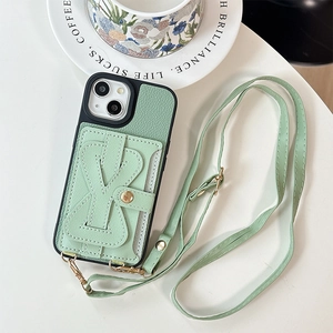 Detail view of mint green leather iPhone case with Y-stitch card holder and gold hardware