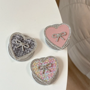 Sparkling rhinestone heart phone socket with elegant bow in leather and tweed fabric textures