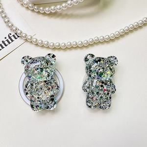 Detailed macro view of 3D bear phone grip with glitter sequins and metal ring stand