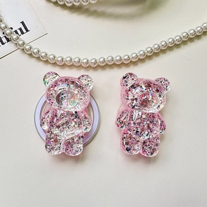 Close-up of bear-shaped glitter phone grips with pink sequins and holographic shimmer