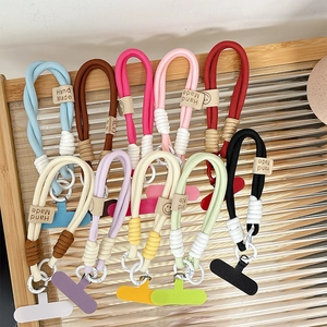 Handmade woven phone wrist straps in multiple colors with silicone patches and charms